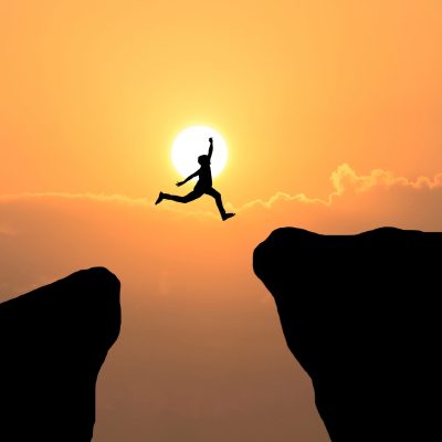 Courage man jump through the gap between hill ,Business concept idea